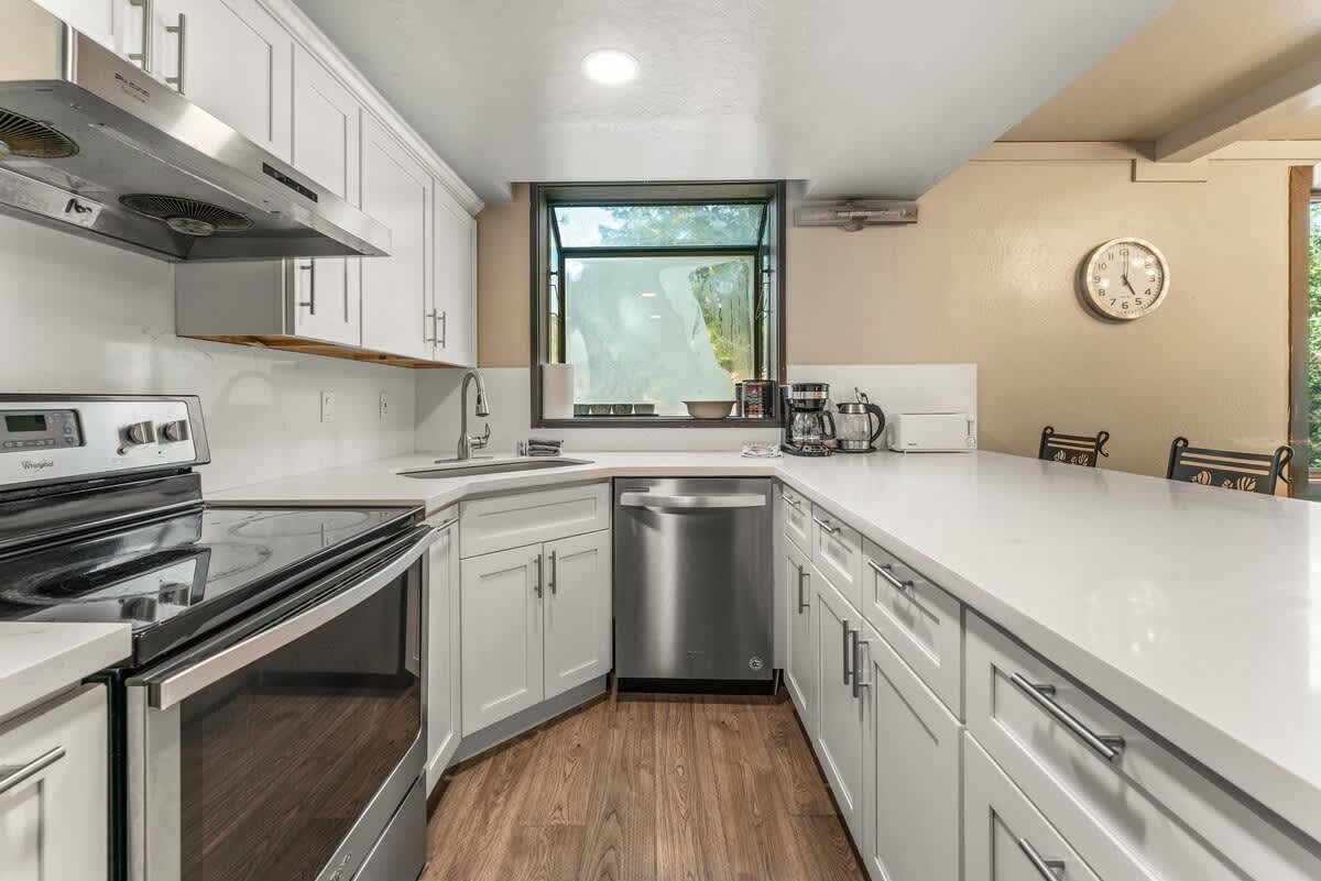 Modern kitchen in Olympic Valley vacation rental with white cabinets and stainless steel appliances.