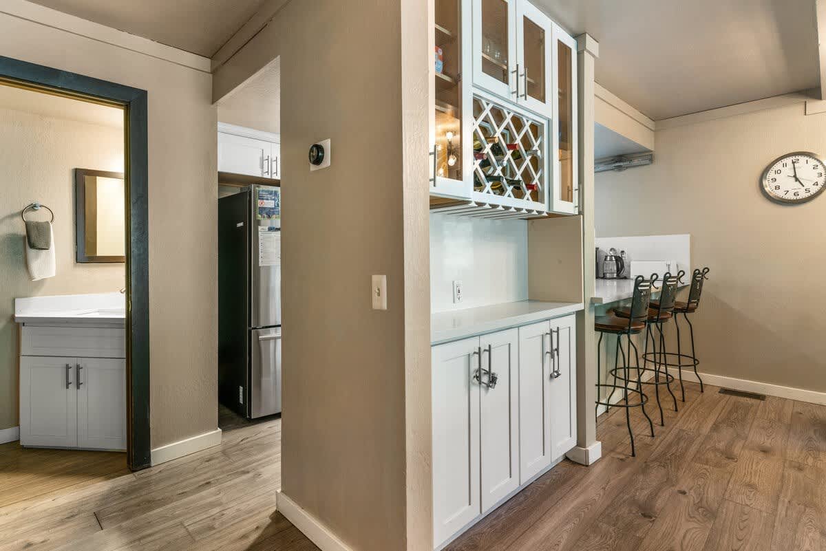 Modern kitchen in Olympic Valley vacation rental with wood floors and breakfast bar seating.