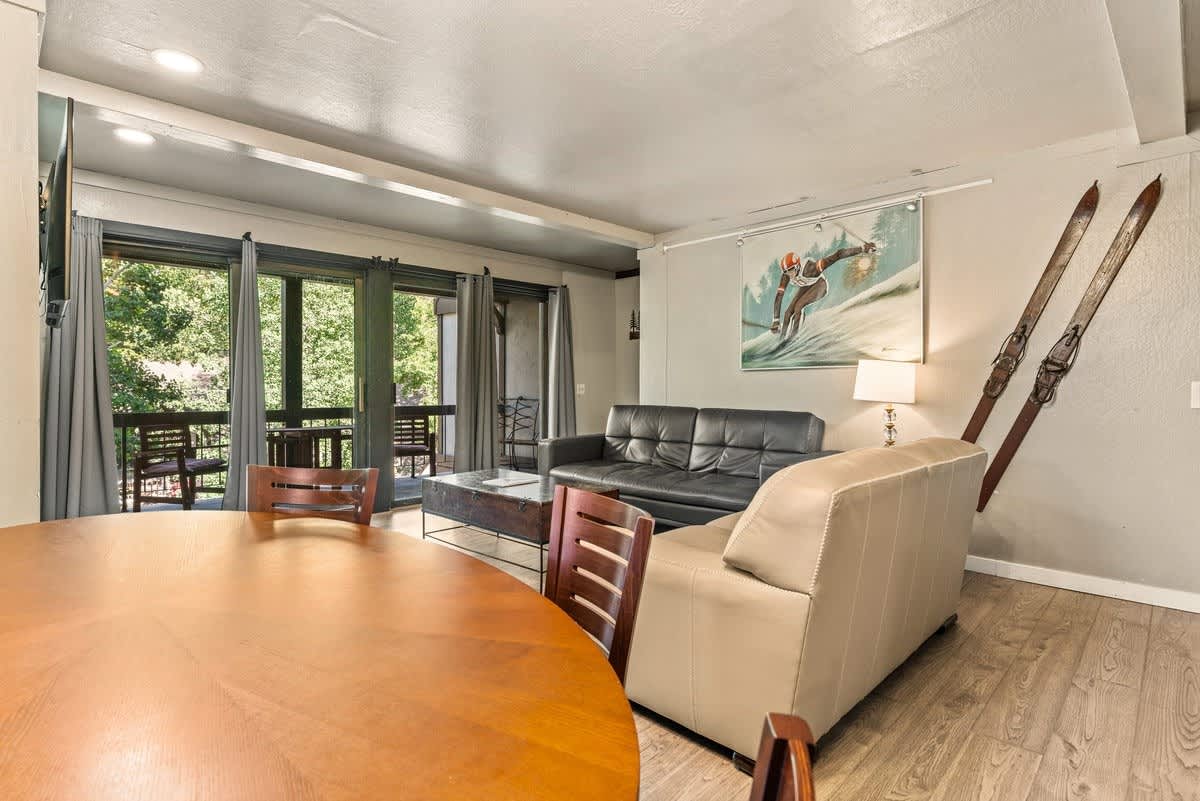 Cozy living room in an Olympic Valley vacation rental with ski decor, large windows, and comfortable seating.