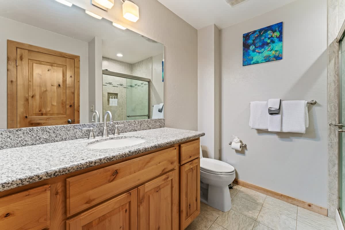 Modern bathroom with wooden accents in a Tahoe City vacation rental.