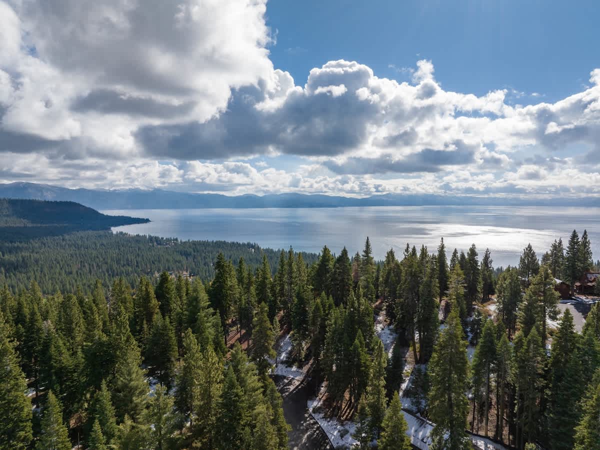 Scenic view of Tahoe Vista's lake and forested mountains, ideal for a tranquil vacation rental experience.