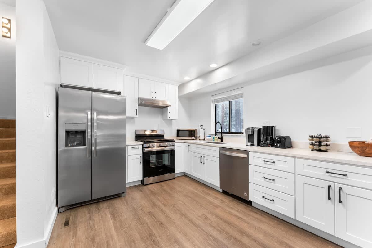 Modern kitchen in a Truckee vacation rental with stainless steel appliances and white cabinets.