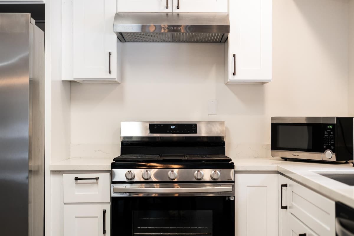 Modern kitchen in a Truckee vacation rental with stainless steel appliances and white cabinets.