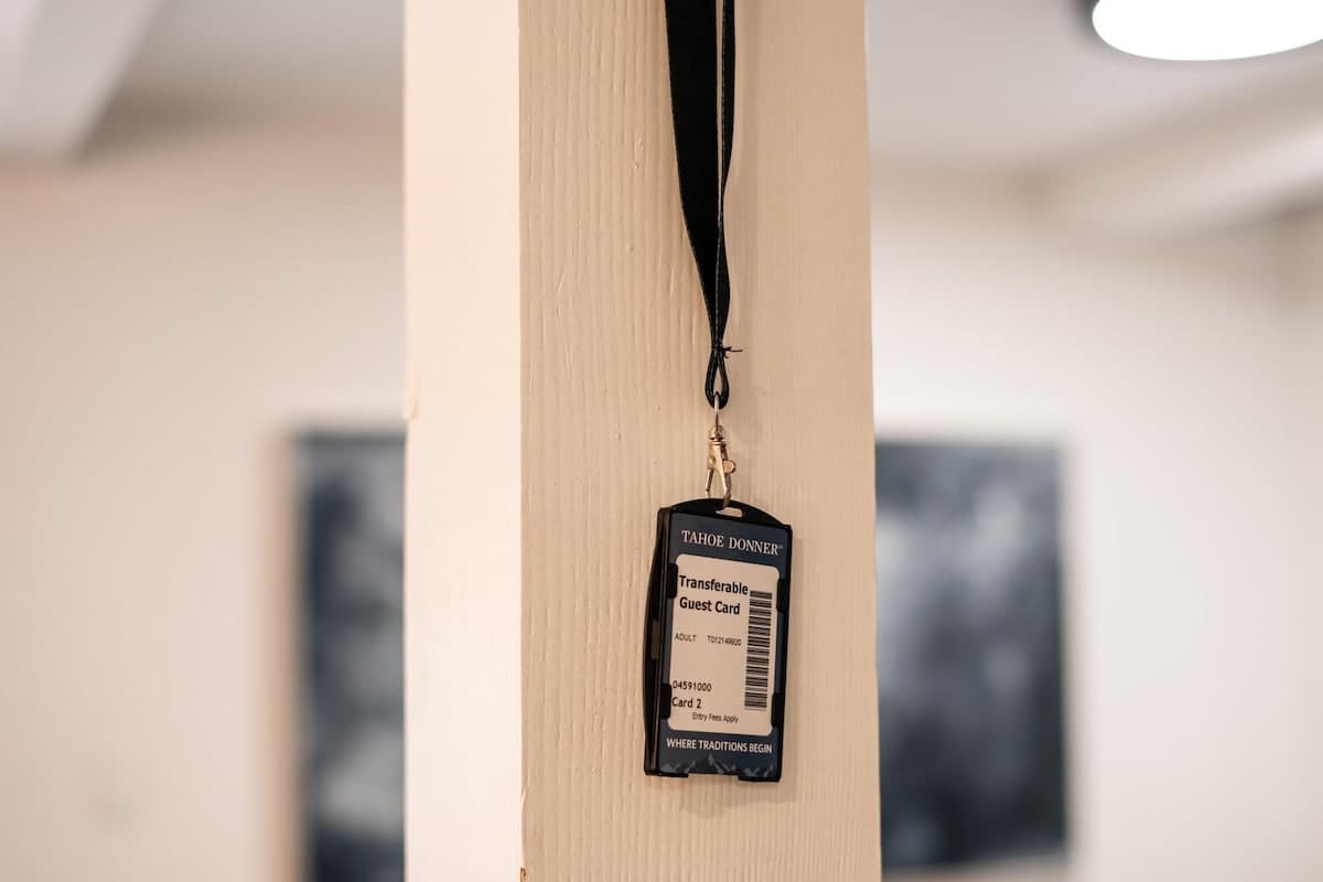 Guest card hanging in a Truckee vacation rental, showcasing the Tahoe Donner transferable guest pass on a lanyard.