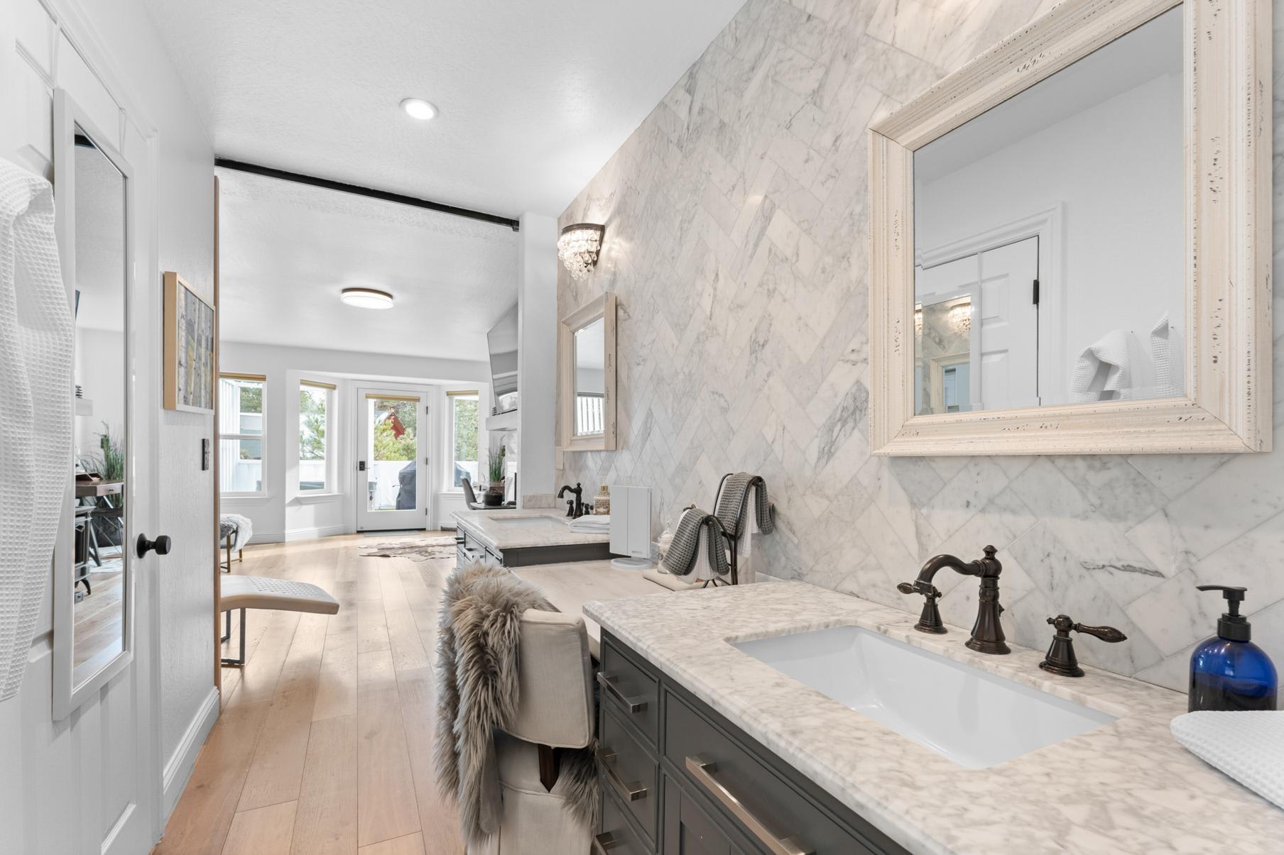 Luxurious bathroom in a Truckee vacation rental with marble countertops, elegant fixtures, and natural light.