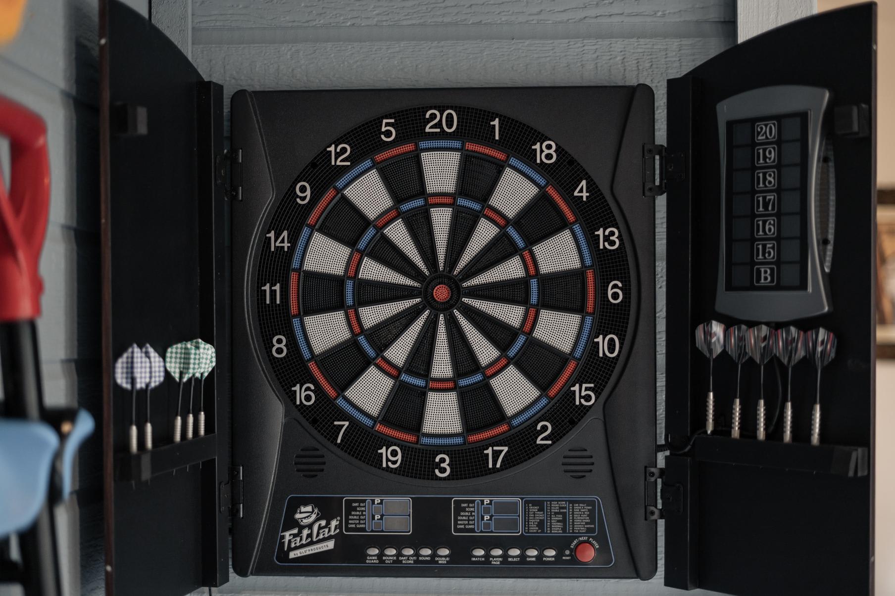 Dartboard with darts in a Truckee vacation rental, offering fun indoor entertainment.