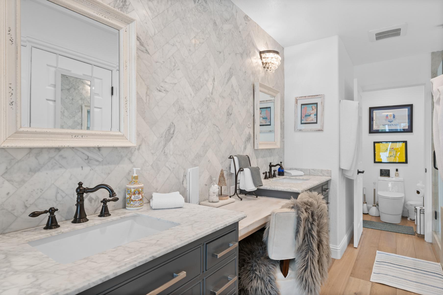 Luxury bathroom in a Truckee vacation rental, featuring marble countertops, stylish mirrors, and modern fixtures.