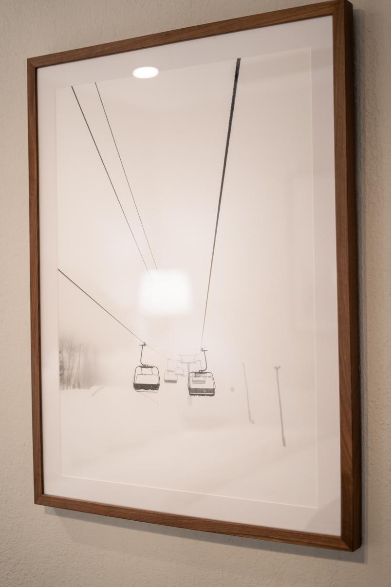 Framed photo of a ski lift in snowy Truckee, hanging on the wall of a vacation rental.