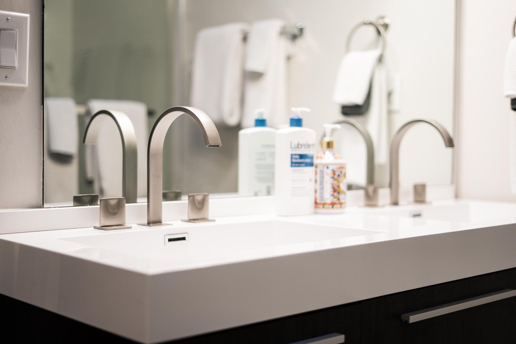 Modern bathroom sink with twin faucets in a Tahoe Vista vacation rental.