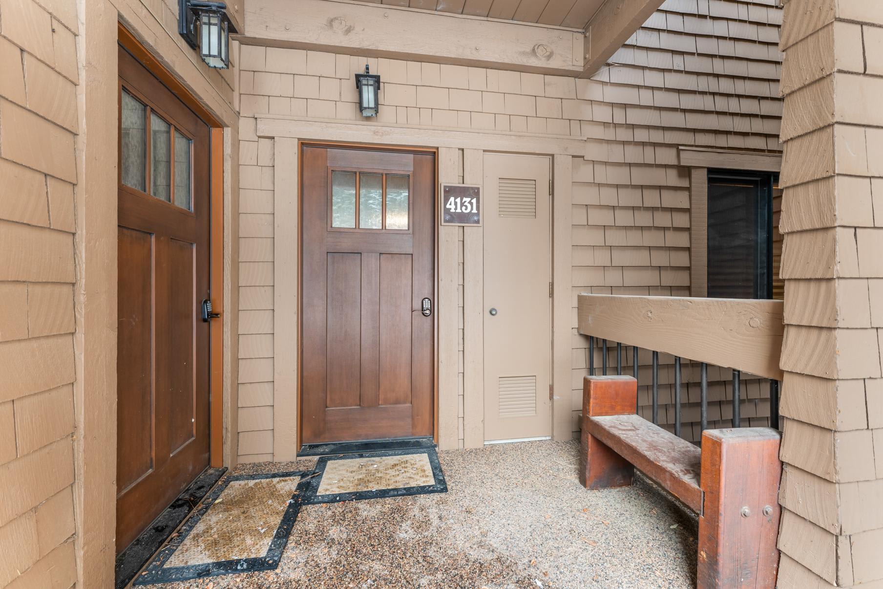 Doorway of a cozy vacation rental in Truckee, featuring wooden accents and a bench by the entrance with unit number 4131.