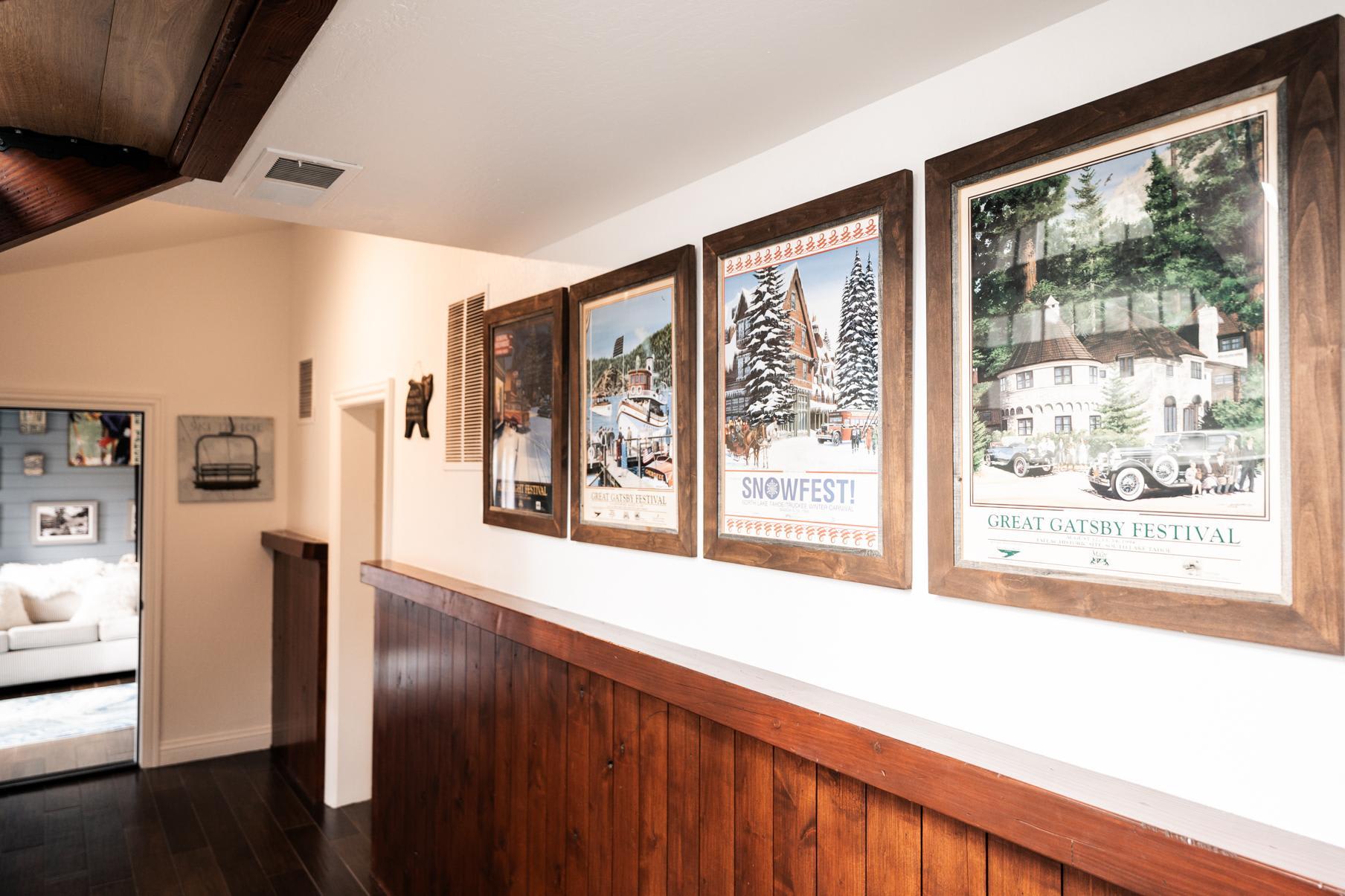 Hallway in a Truckee vacation rental with framed festival posters on a wooden wall.