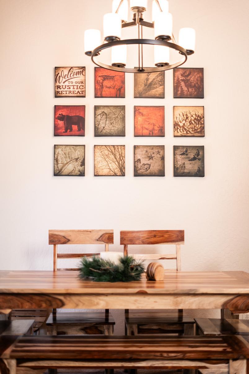 Dining area in Truckee vacation rental with rustic decor and wooden furniture under a modern chandelier.