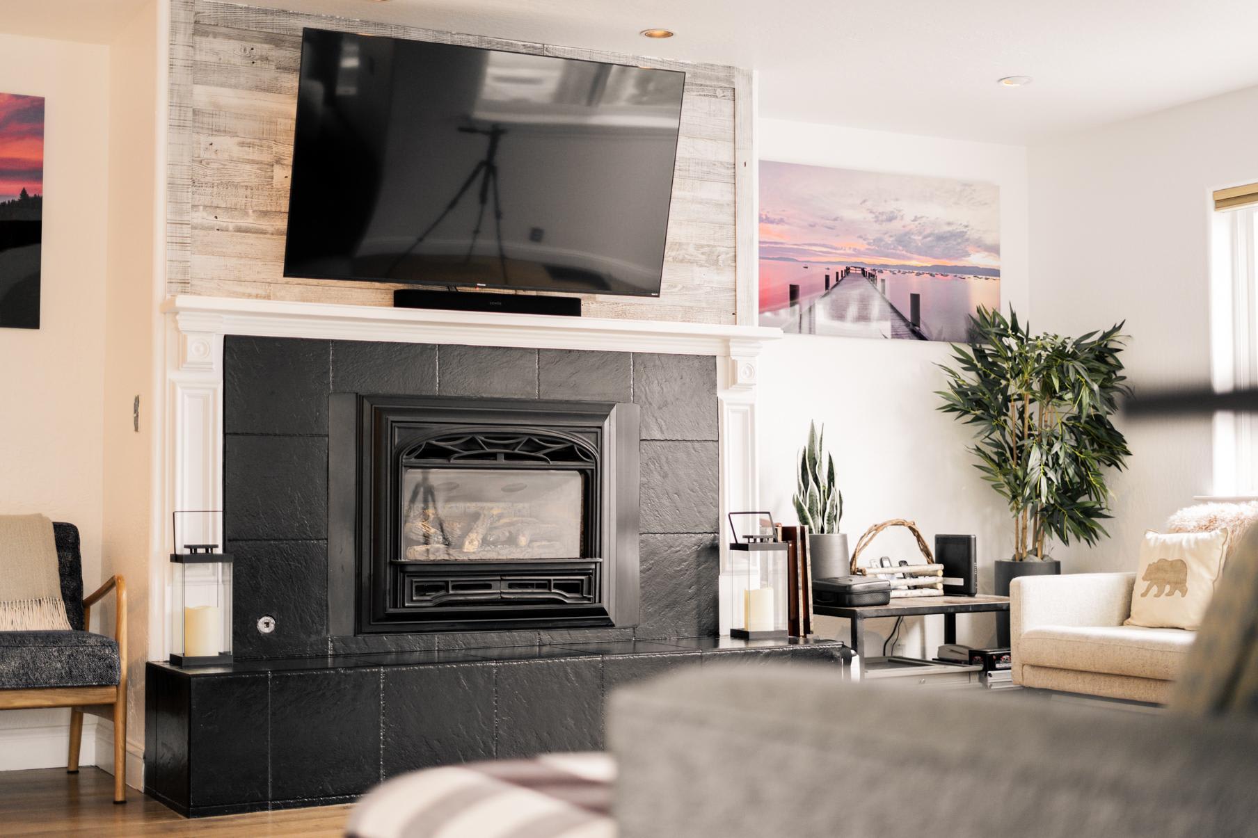 Cozy living room in a Truckee vacation rental with a modern fireplace, large TV, and elegant decor.