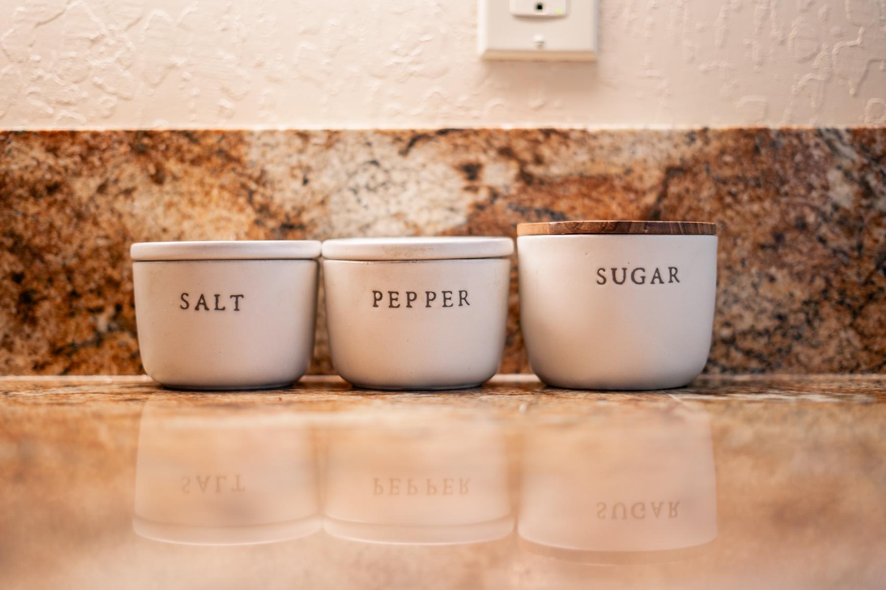 Salt, pepper, and sugar containers on a granite countertop in a Truckee vacation rental kitchen.