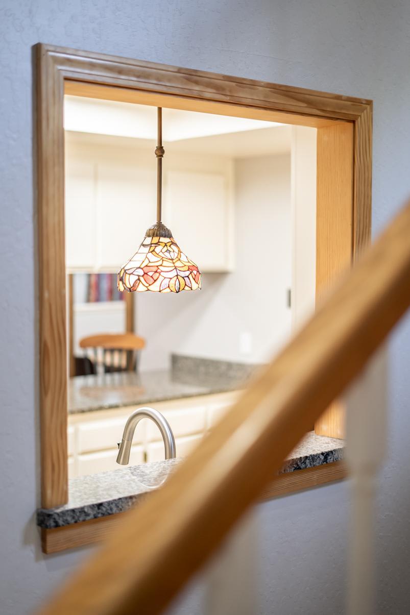 Cozy kitchen view in a Truckee vacation rental, featuring a colorful pendant lamp and granite countertops.