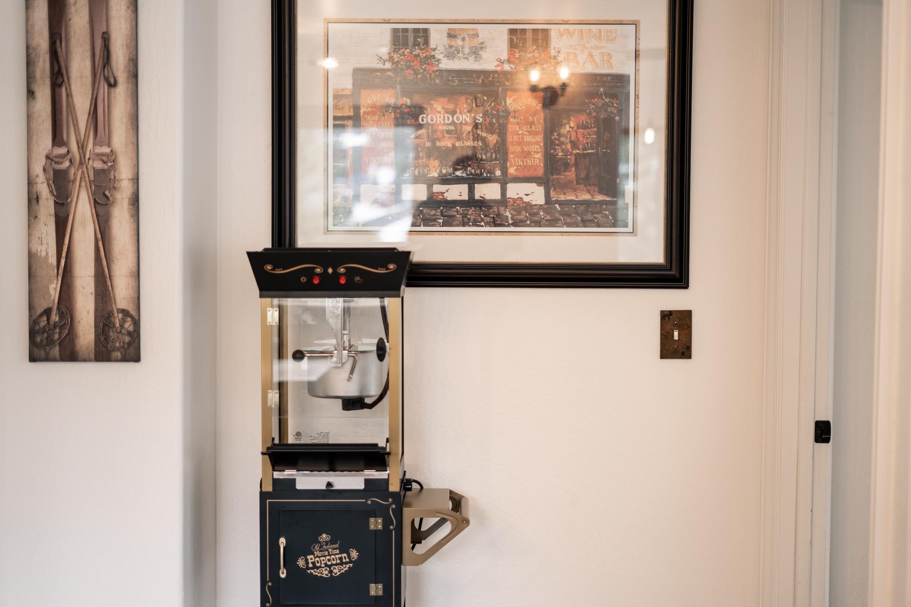 Popcorn machine in a cozy Truckee vacation rental, with ski decor and a framed artwork on the wall.