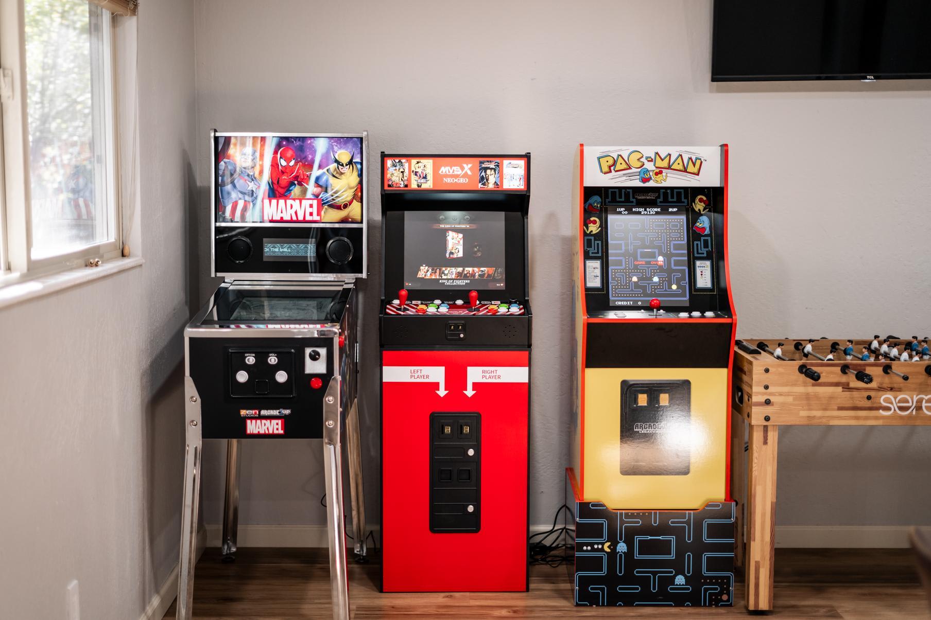 Arcade games and foosball in a Truckee vacation rental, featuring Marvel, Neo Geo, and Pac-Man machines.