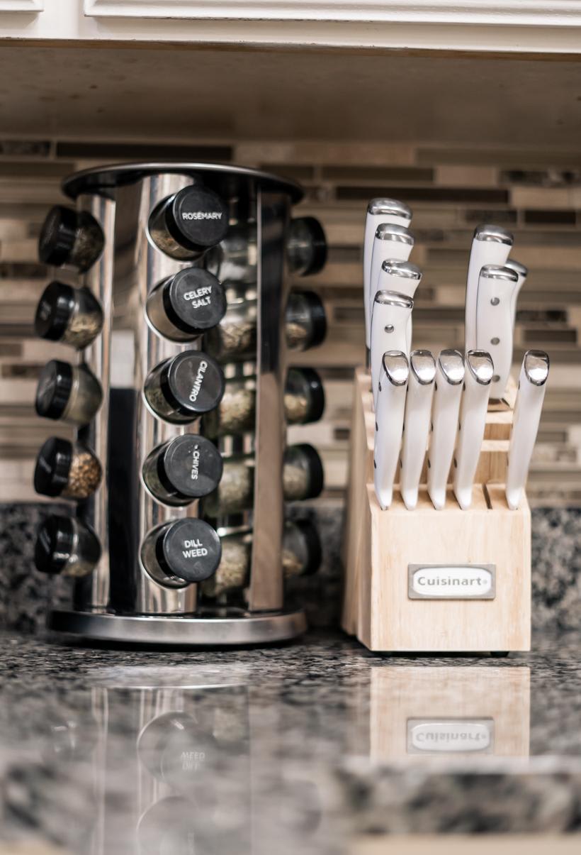 Knife set and spice rack on a granite countertop in a Truckee vacation rental kitchen.