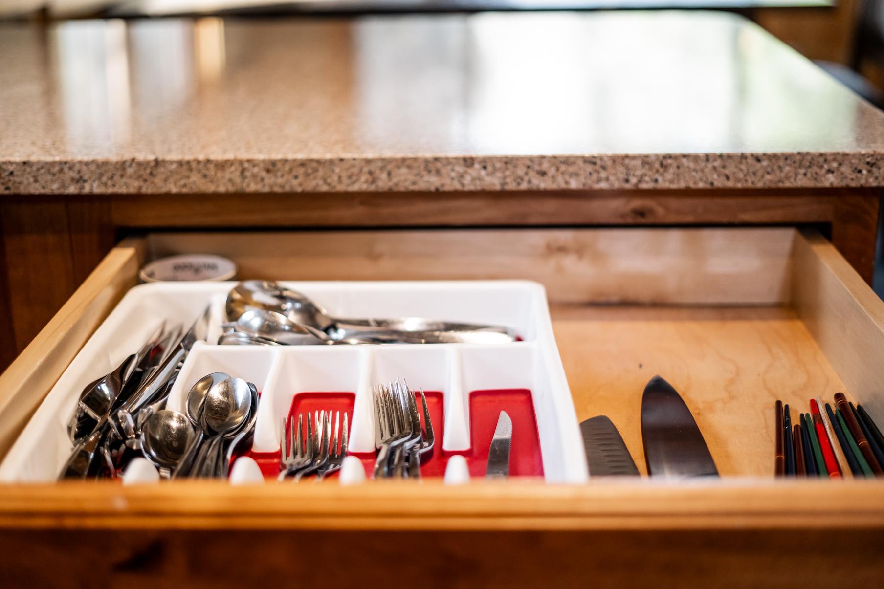 Open drawer with organized cutlery in a Truckee vacation rental kitchen, highlighting neat utensils.