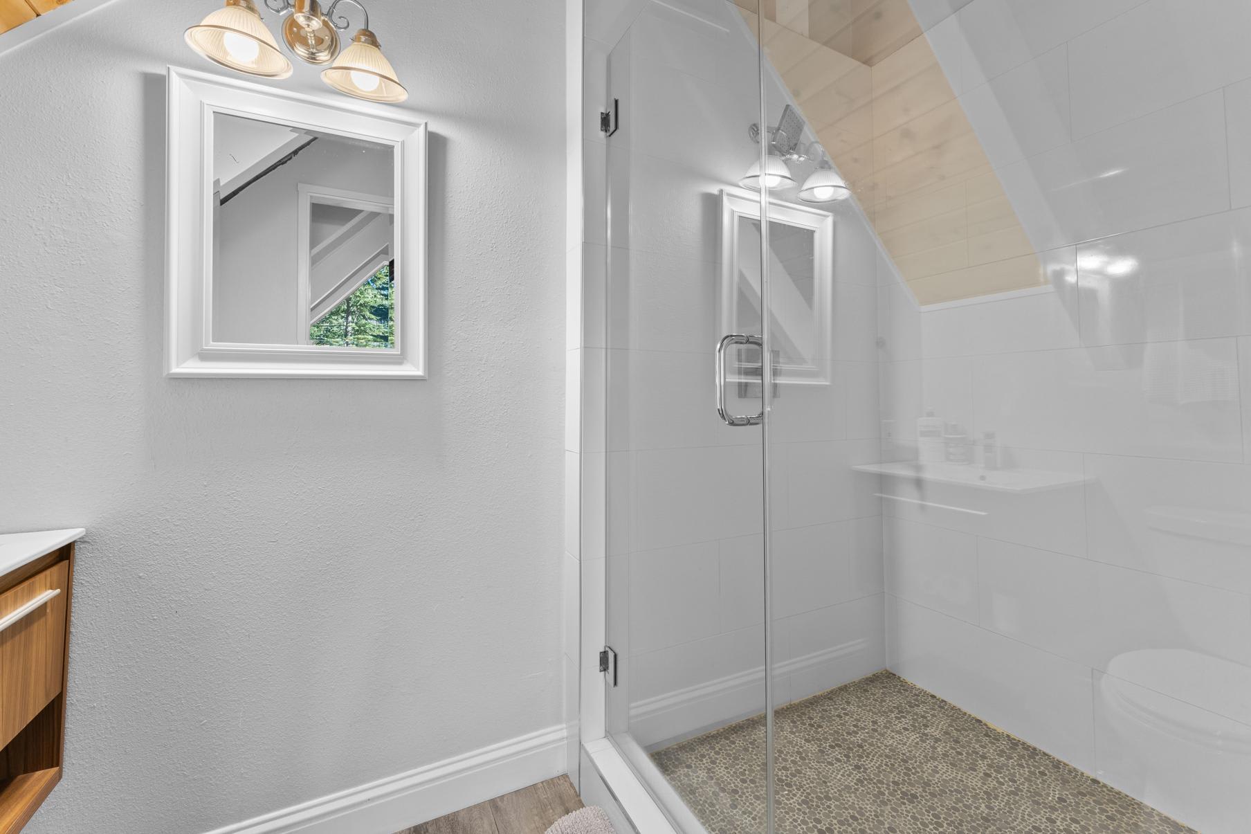 Modern bathroom with glass shower in Tahoe Vista vacation rental.