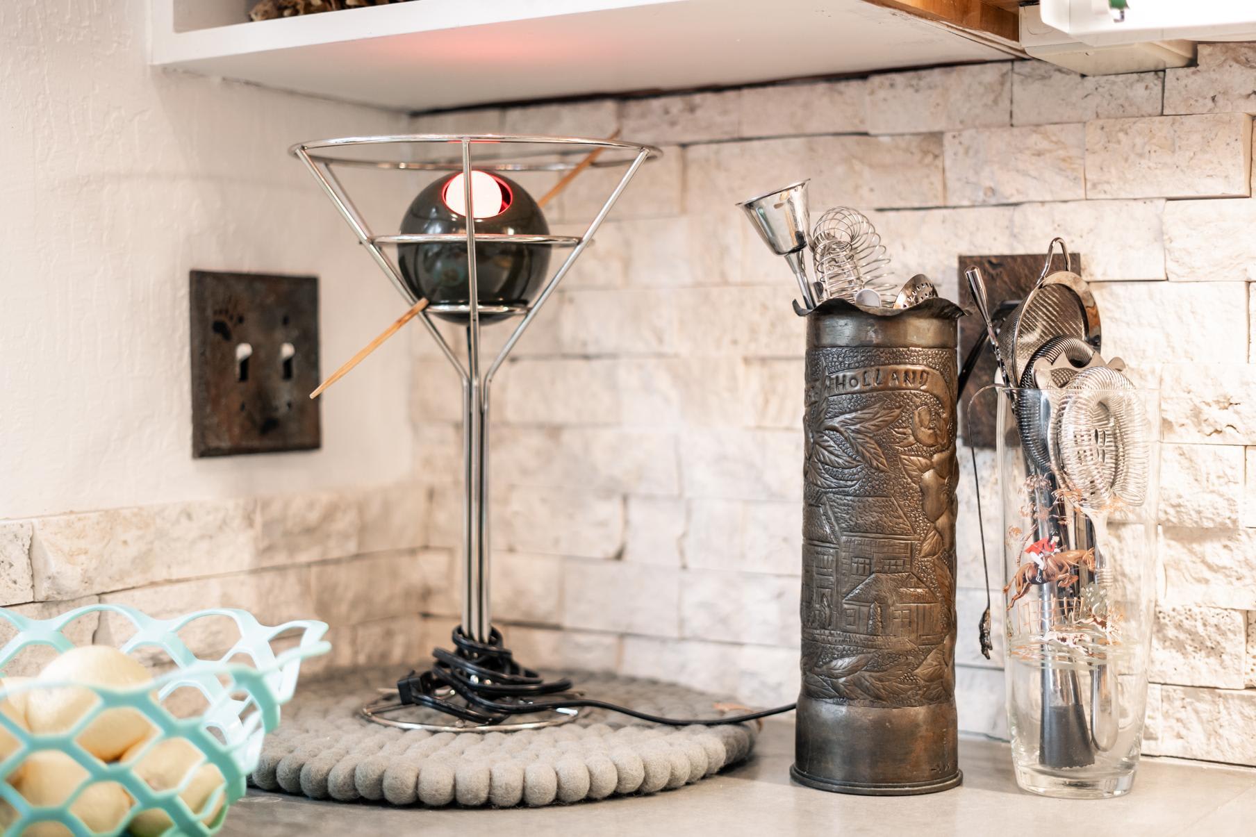 Decorative items on a counter in a Truckee vacation rental kitchen, including a unique lamp and vintage containers.