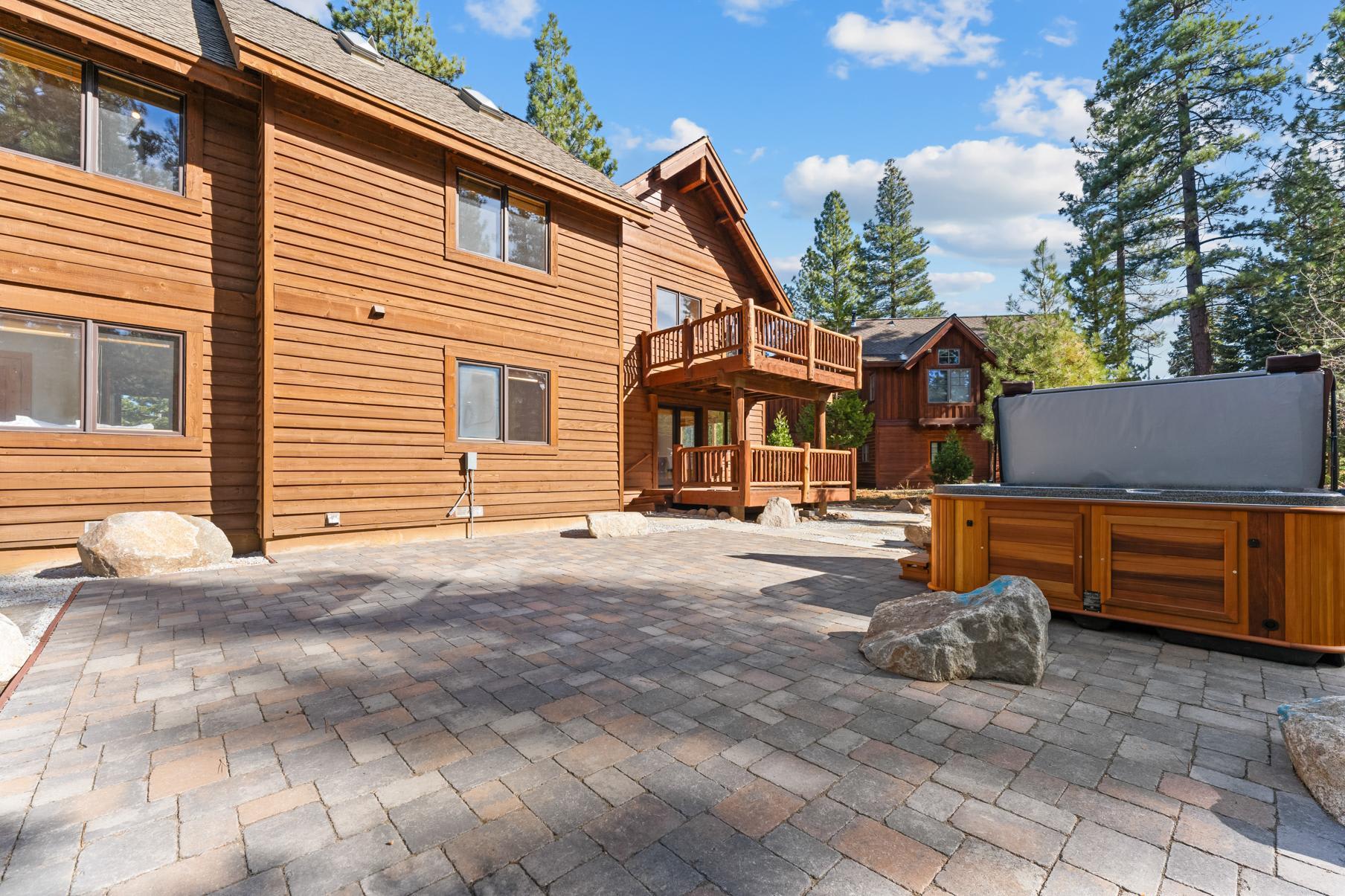 Wooden vacation rental in Truckee with spacious patio, hot tub, and scenic forest surroundings.