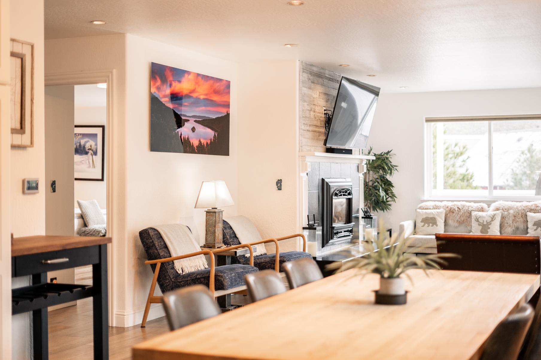 Cozy interior of a Truckee vacation rental with modern decor, fireplace, and large dining table.