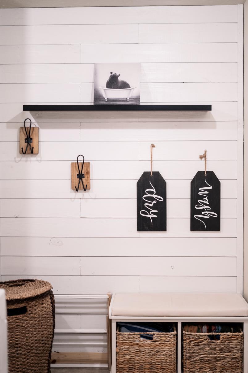 Cozy Truckee vacation rental entryway with decorative wall, hooks, and storage baskets, featuring a playful bear photo.