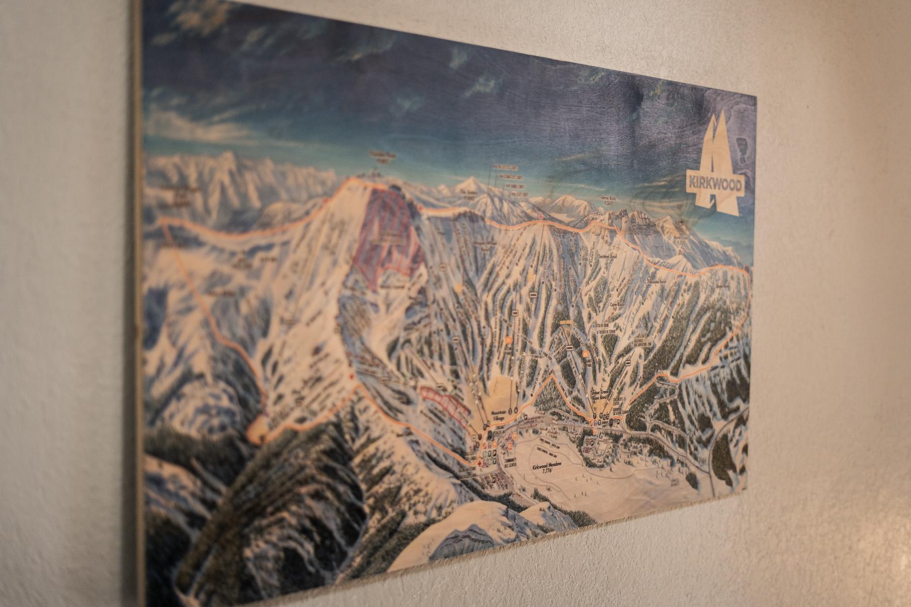 Wall art depicting a ski resort map in a Truckee vacation rental, showcasing mountainous terrain and ski trails.