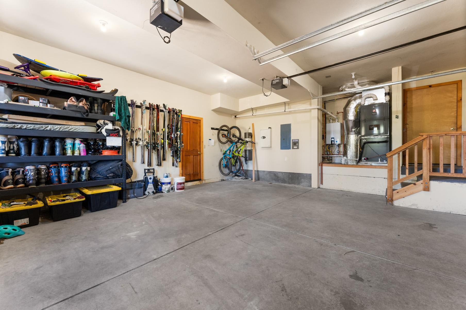 Garage of a Truckee vacation rental, featuring sports equipment like skis and bikes organized neatly on racks.