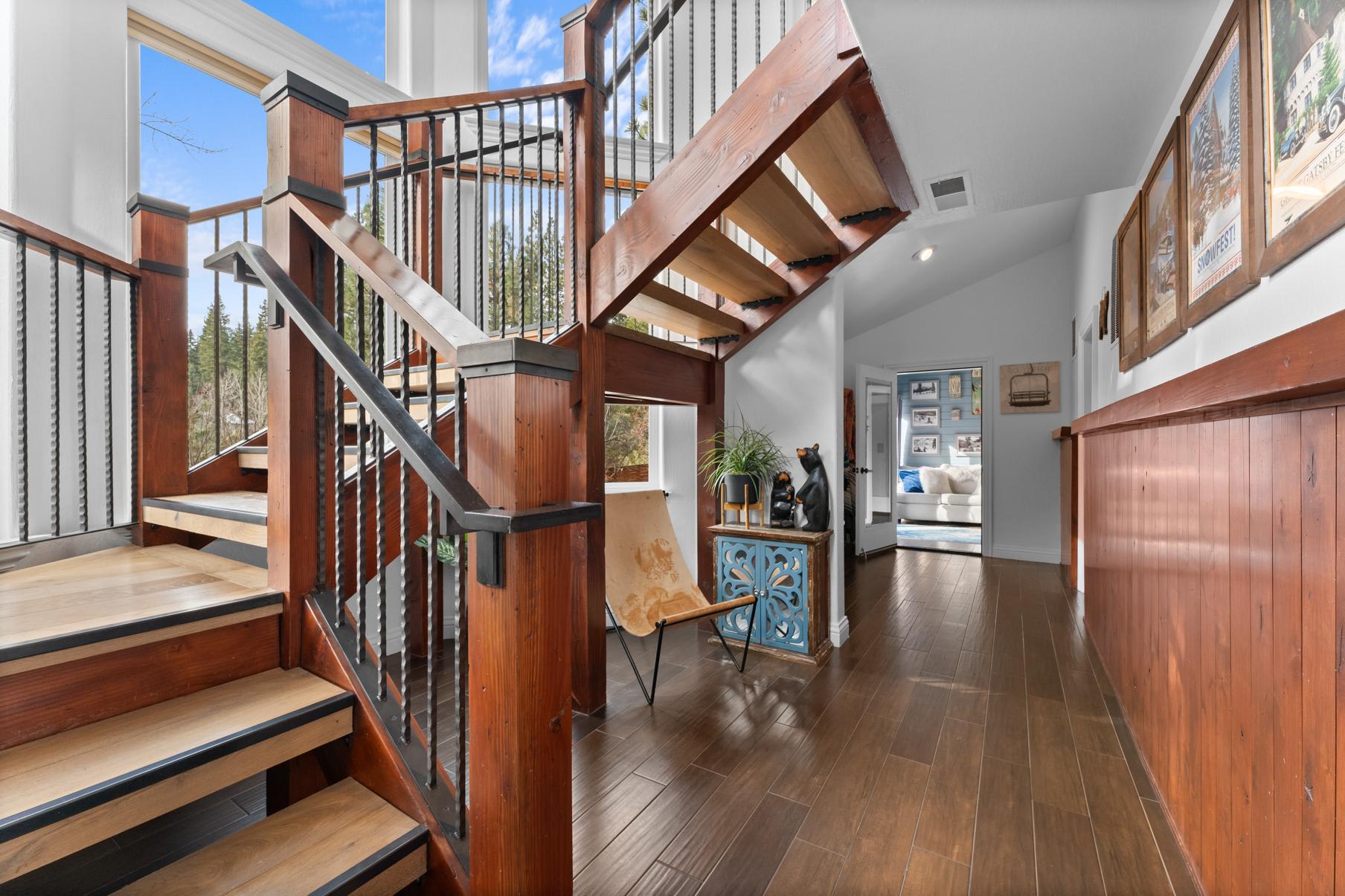 Wooden staircase and decor in a Truckee vacation rental, featuring bright interiors and artistic touches.