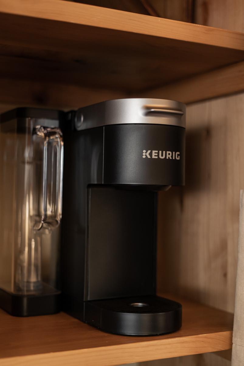 Coffee maker on a wooden shelf in a Truckee vacation rental, providing comfort and convenience for guests.