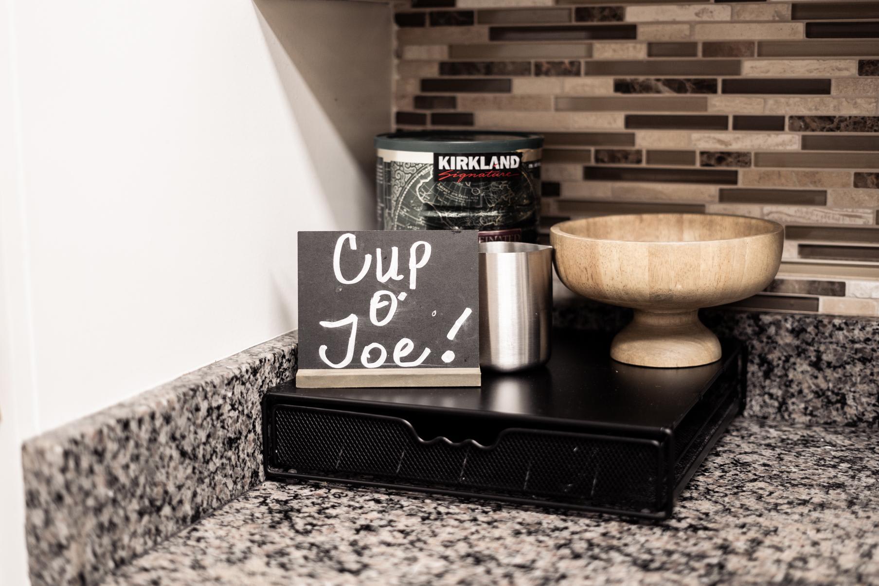 Coffee setup with a "Cup o' Joe" sign in a Truckee vacation rental kitchen.