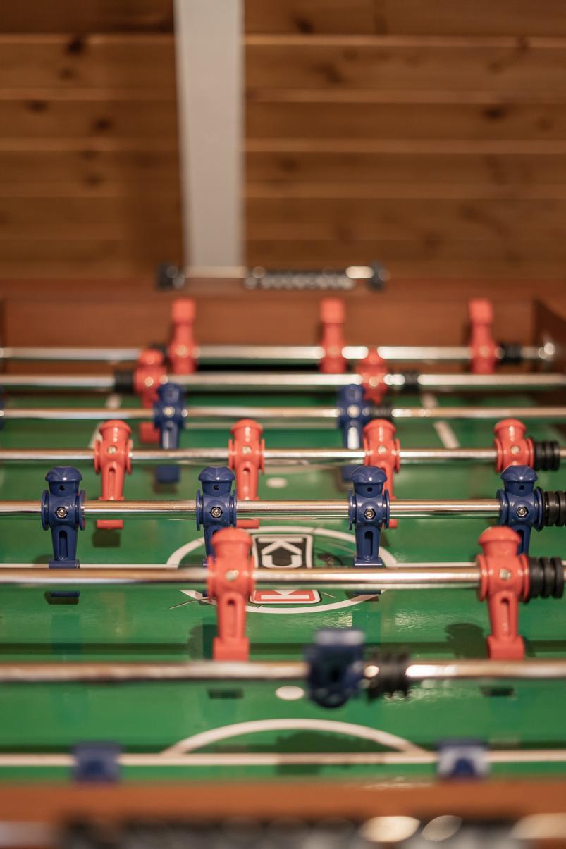 Foosball table in a Tahoe Vista vacation rental with wooden walls in the background.