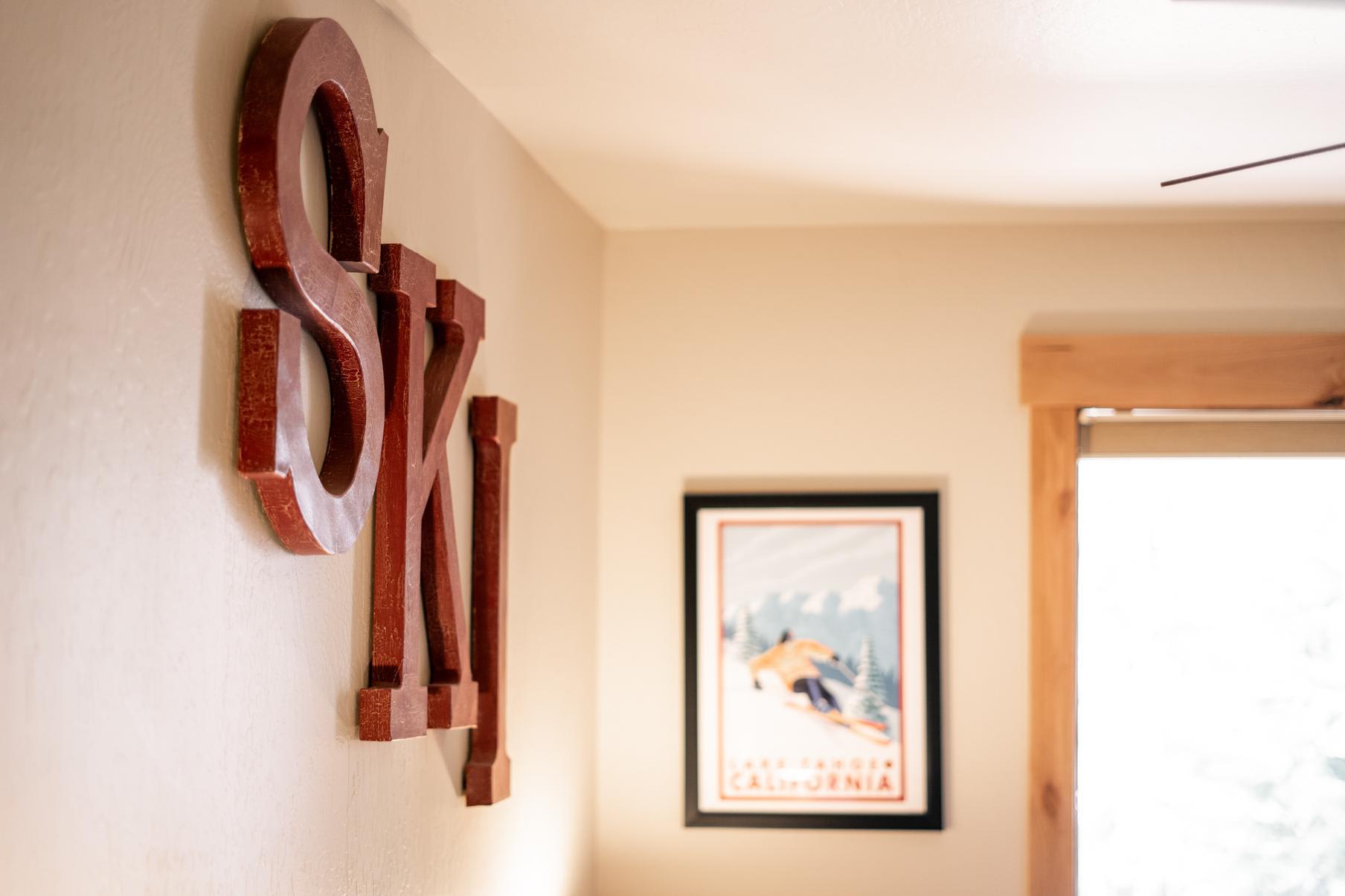 Vacation rental in Truckee with rustic "SKI" decor and vintage skiing poster on the wall.