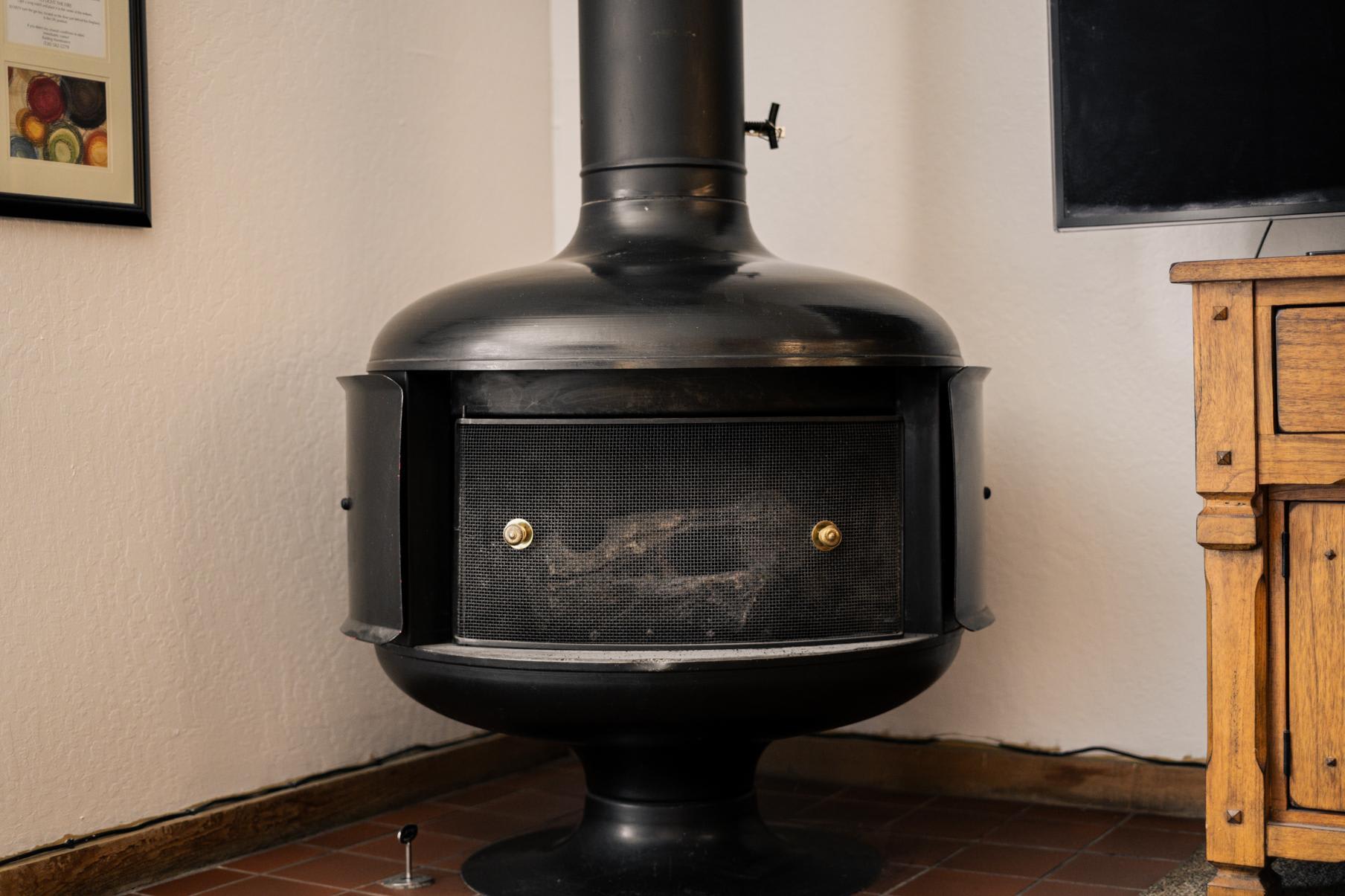 Vintage stove in a Truckee vacation rental, beside a wooden cabinet, creating a cozy ambiance.