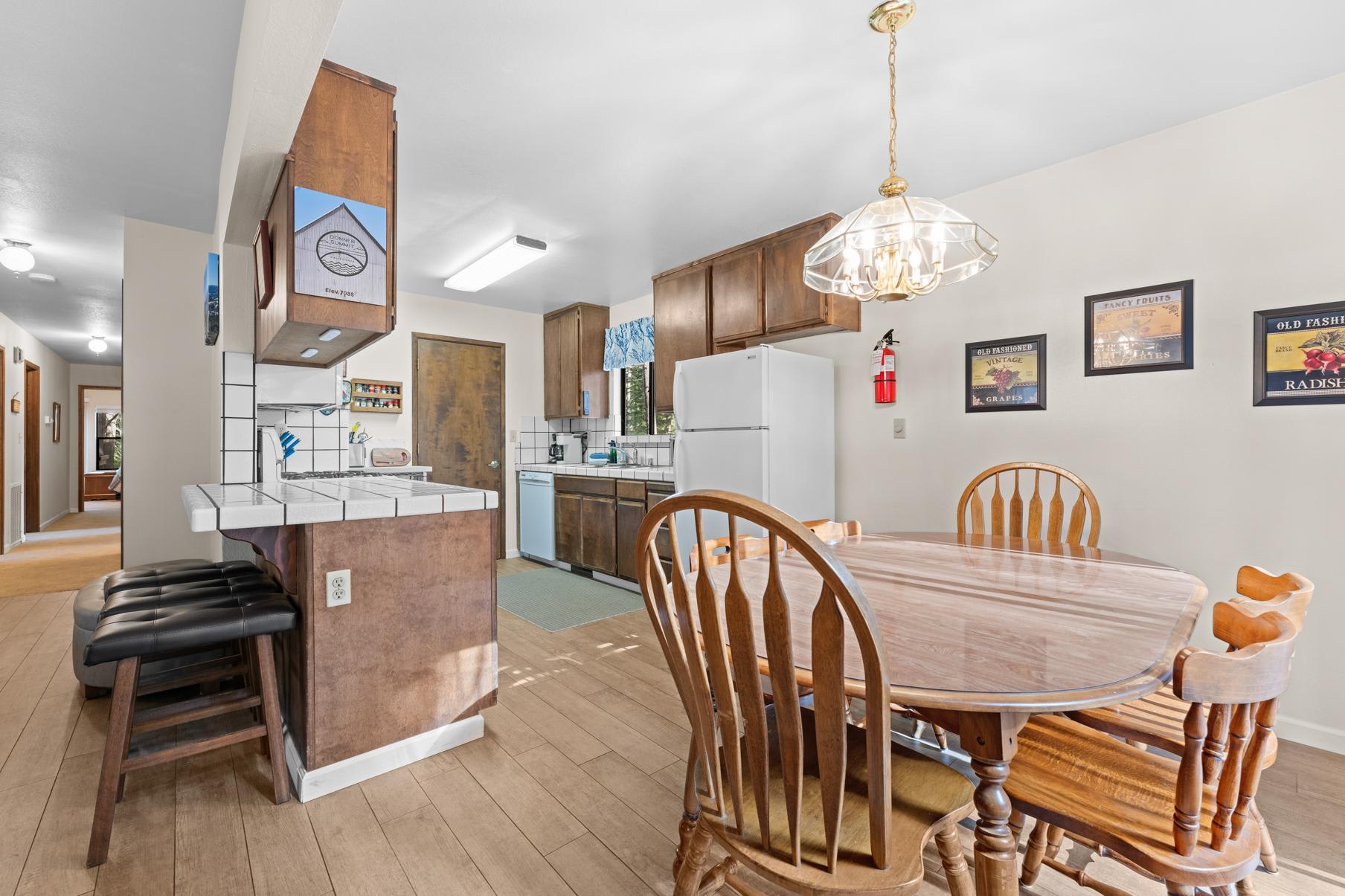 Cozy kitchen and dining area in a Truckee vacation rental, featuring wooden cabinets and decor with vintage accents.