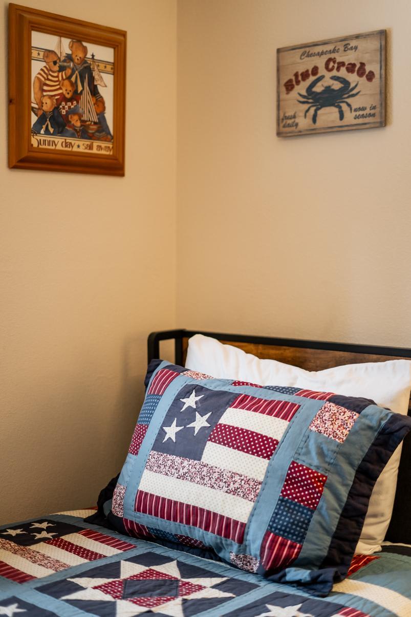 Cozy bedroom in Truckee vacation rental with nautical decor and patriotic quilt bedding.