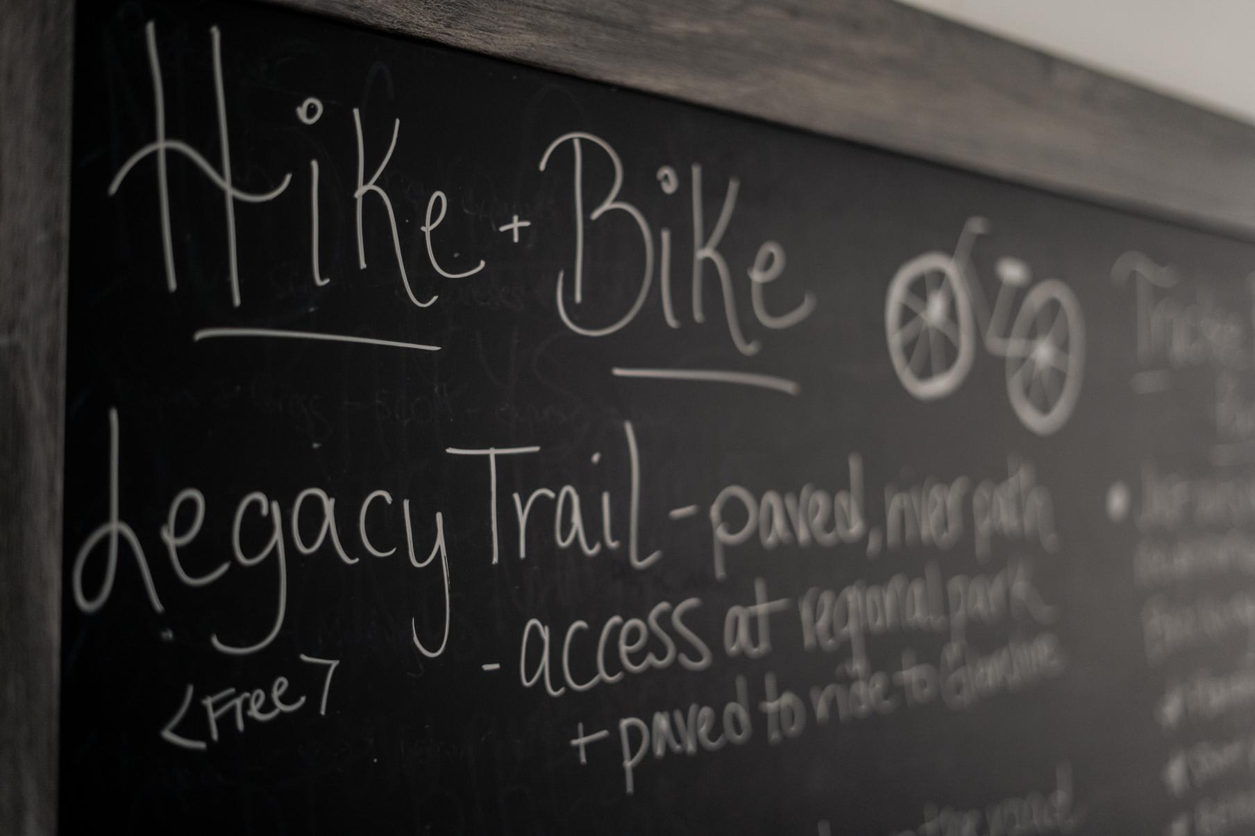 Chalkboard in a Truckee vacation rental lists hiking and biking trails, including the Legacy Trail with access details.