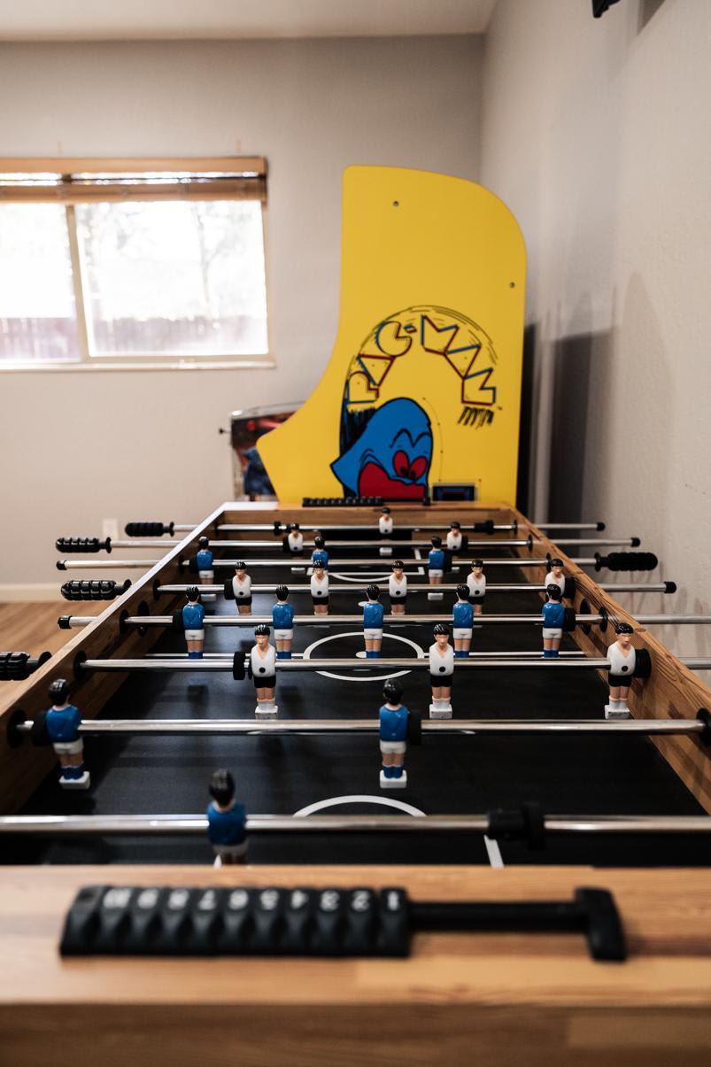 Foosball table and Pac-Man arcade in a Truckee vacation rental game room.