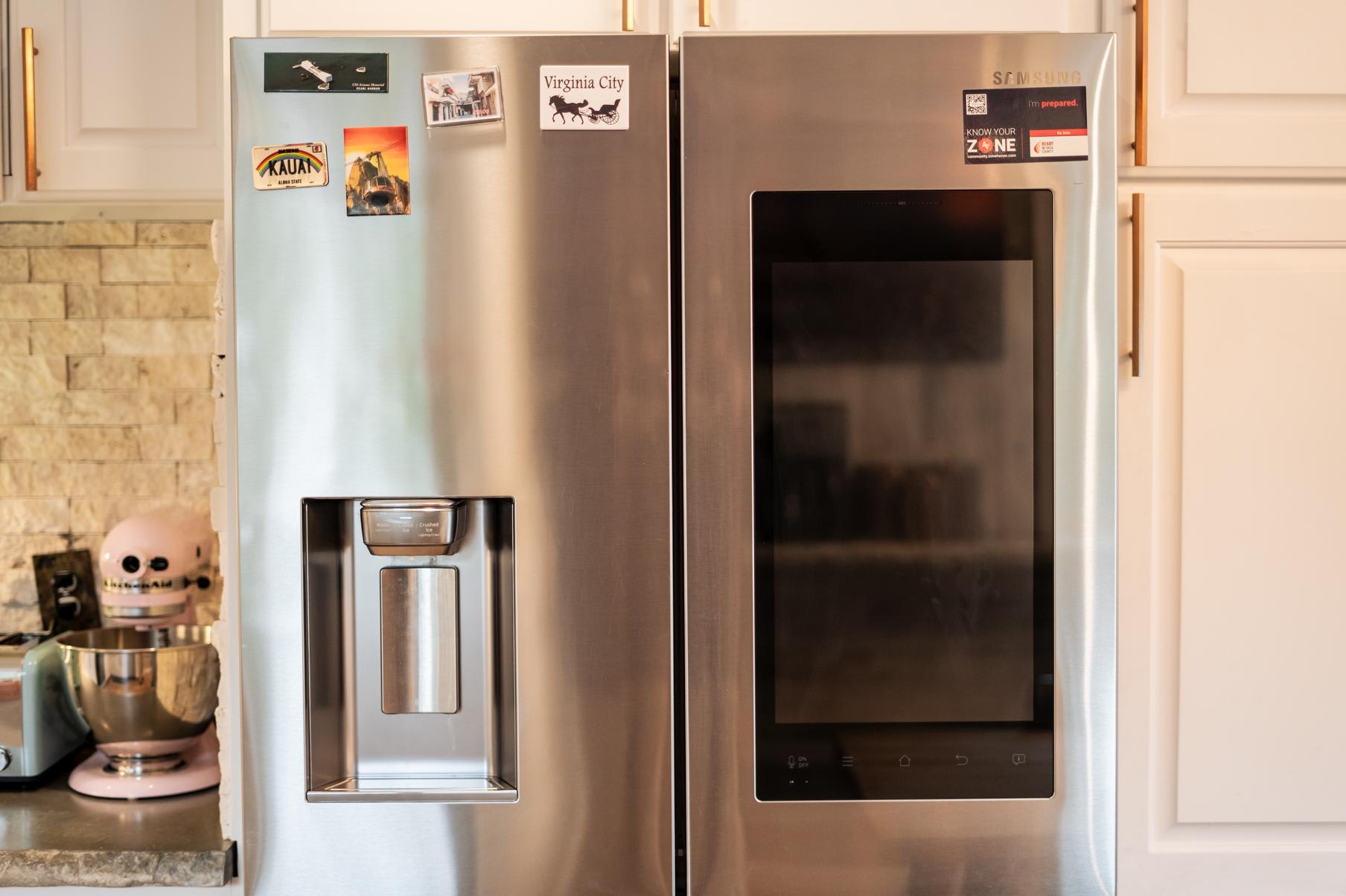 Modern stainless steel fridge in a Truckee vacation rental kitchen with magnets on the doors.