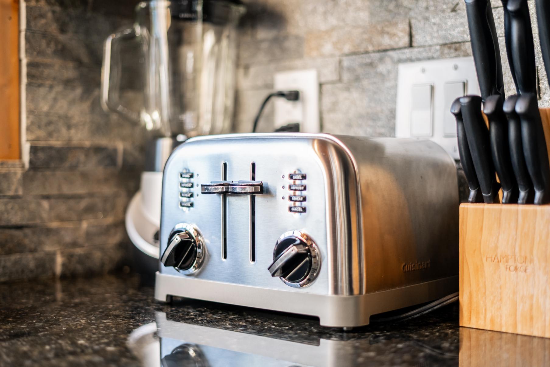 Modern kitchen in Truckee vacation rental with a stainless steel toaster, blender, and knife set on a counter.