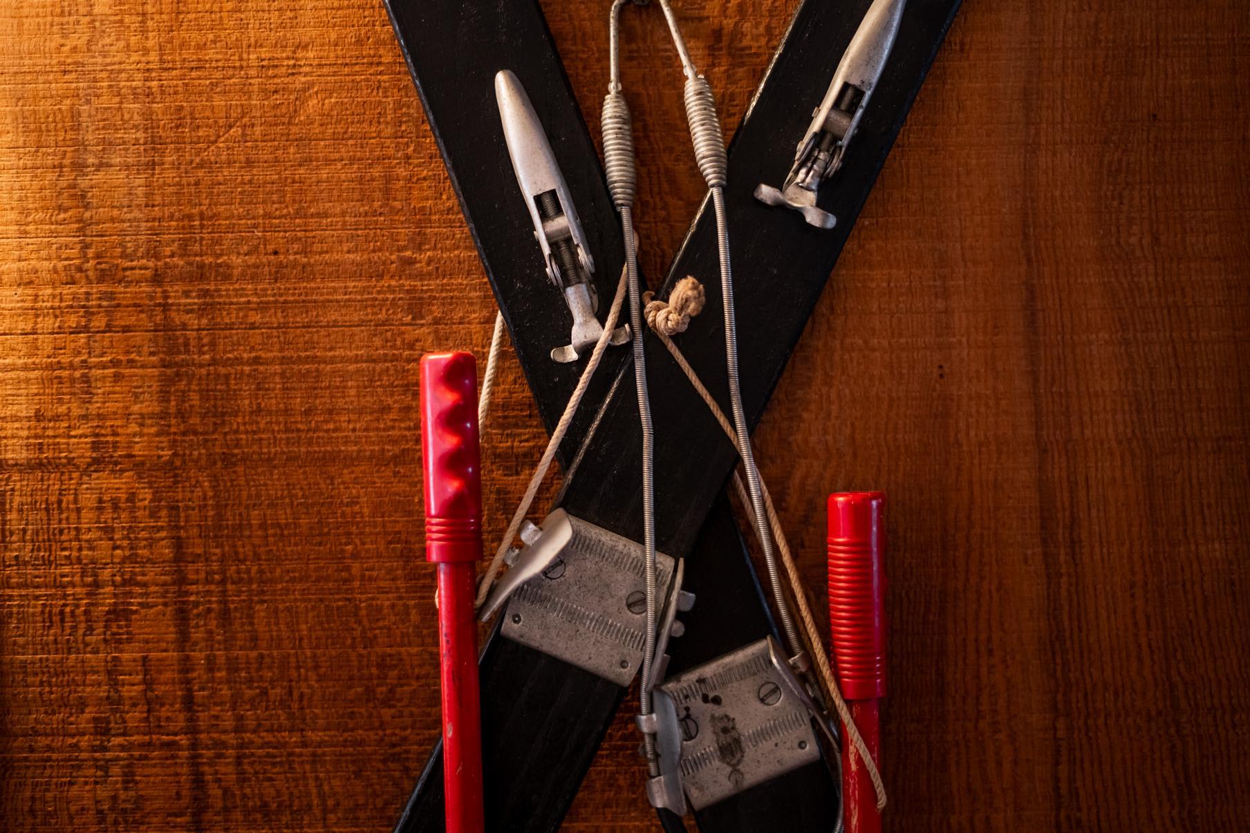 Vintage skiing equipment decorates a wooden wall in a Truckee vacation rental.