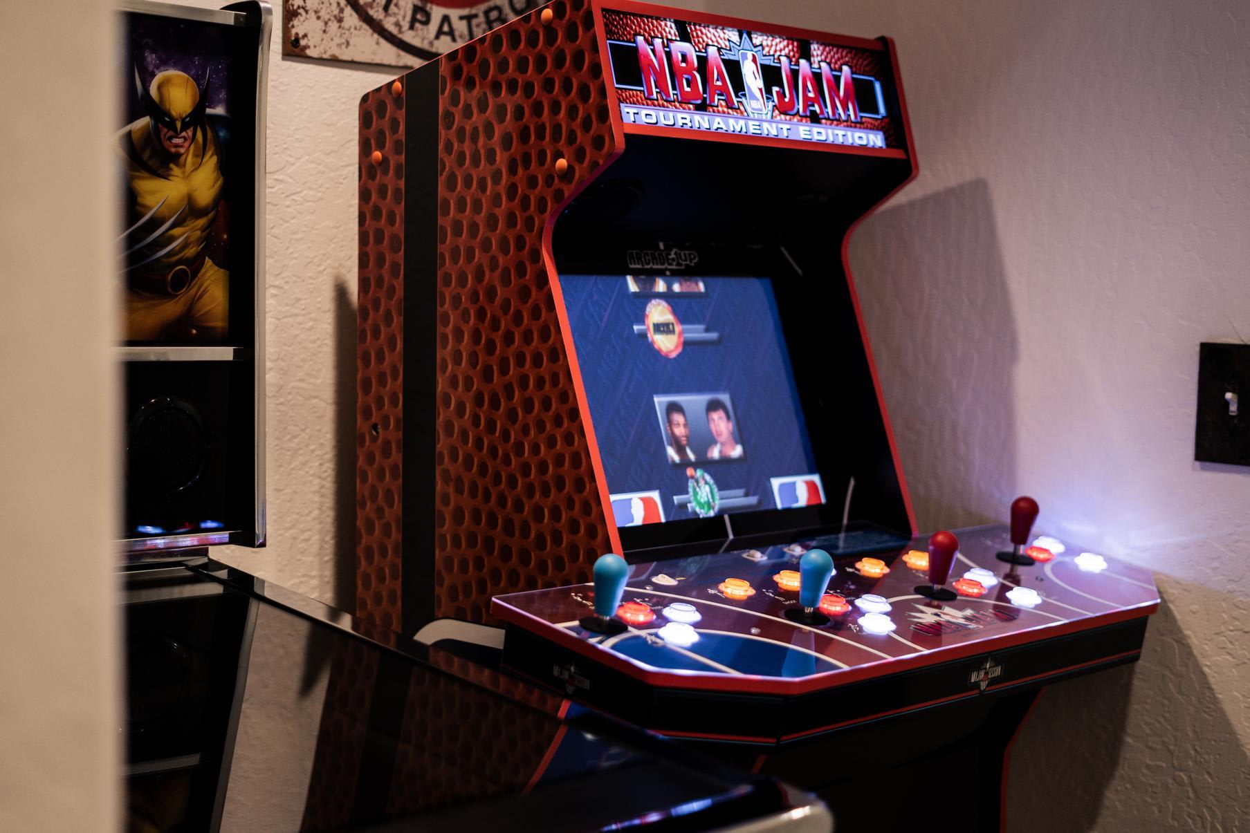 Arcade game setup in a Truckee vacation rental, featuring NBA Jam Tournament Edition with vibrant controls.