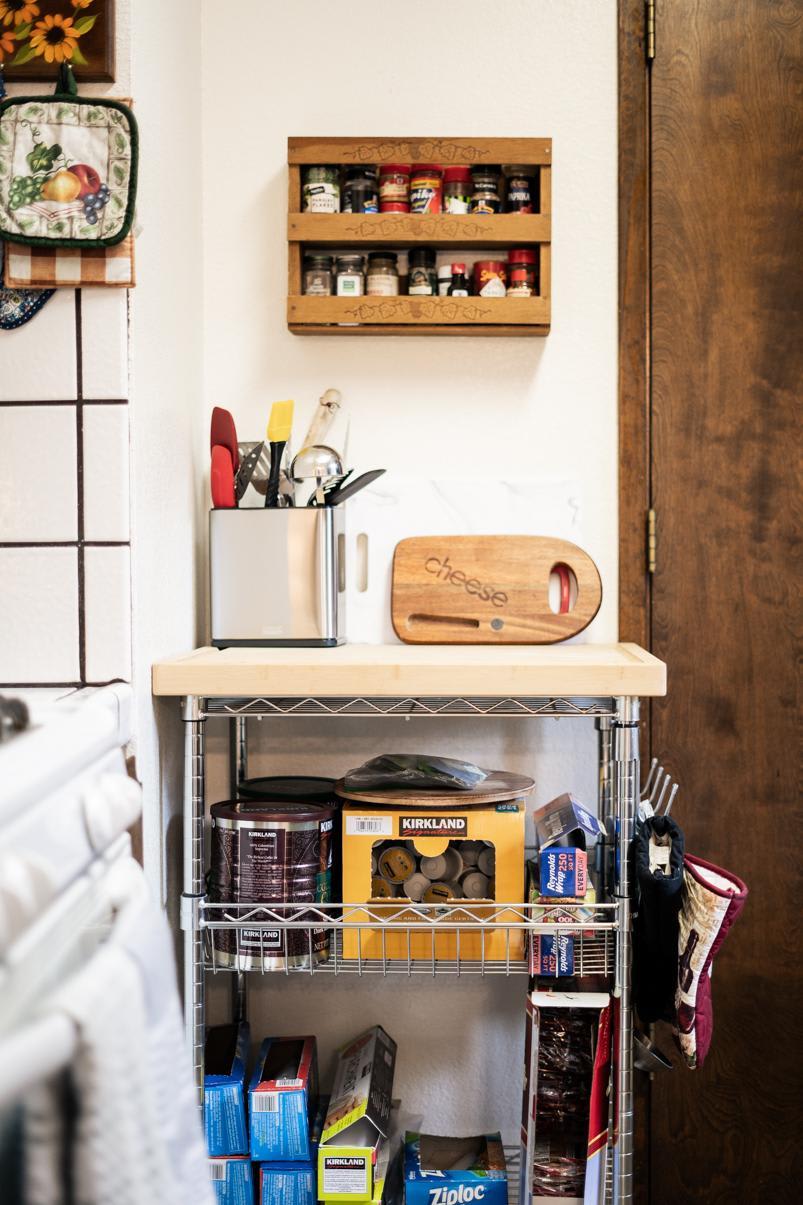 Kitchen nook in a Truckee vacation rental with spice rack, utensils, and storage shelves.