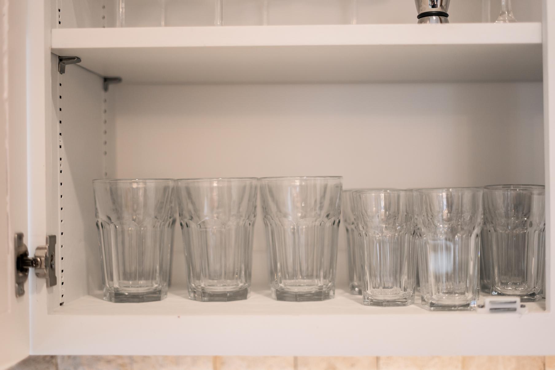 Glassware neatly arranged in the kitchen cabinet of a Truckee vacation rental.