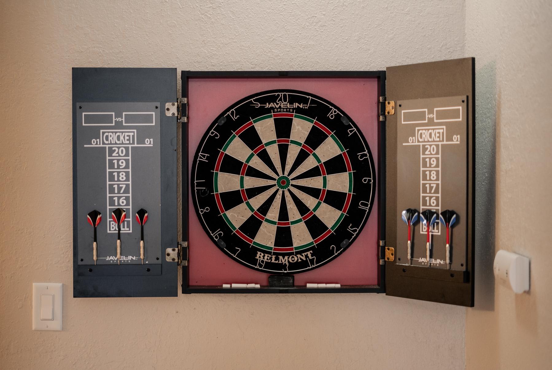 Dartboard and darts in a Truckee vacation rental, ready for a fun game in the cozy space.