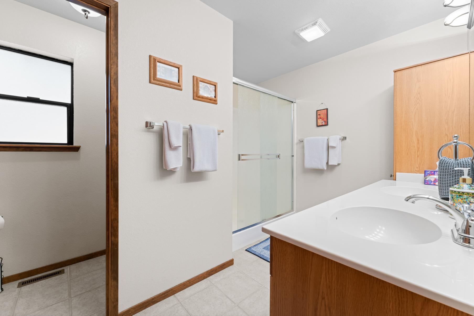 Bathroom in Truckee vacation rental with a walk-in shower, framed art, and a vanity with sink.