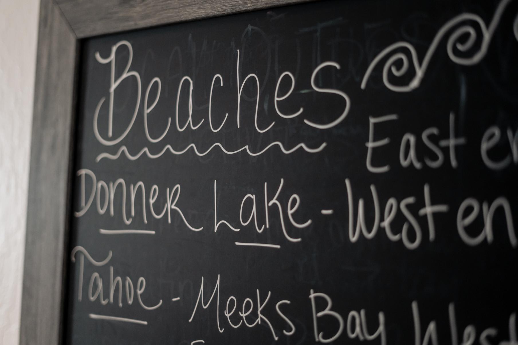 Chalkboard in a Truckee vacation rental listing local beaches like Donner Lake and Tahoe attractions.