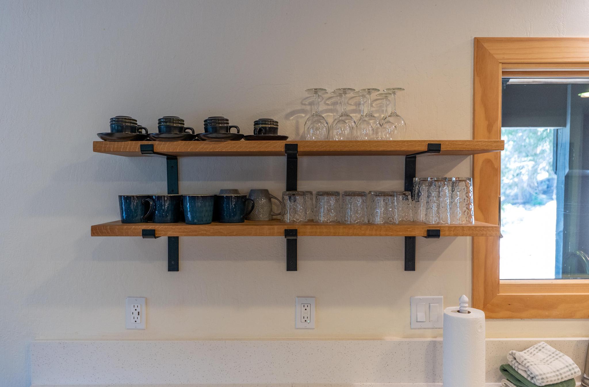 Open shelves with cups and glasses in a Tahoe Vista vacation rental kitchen.